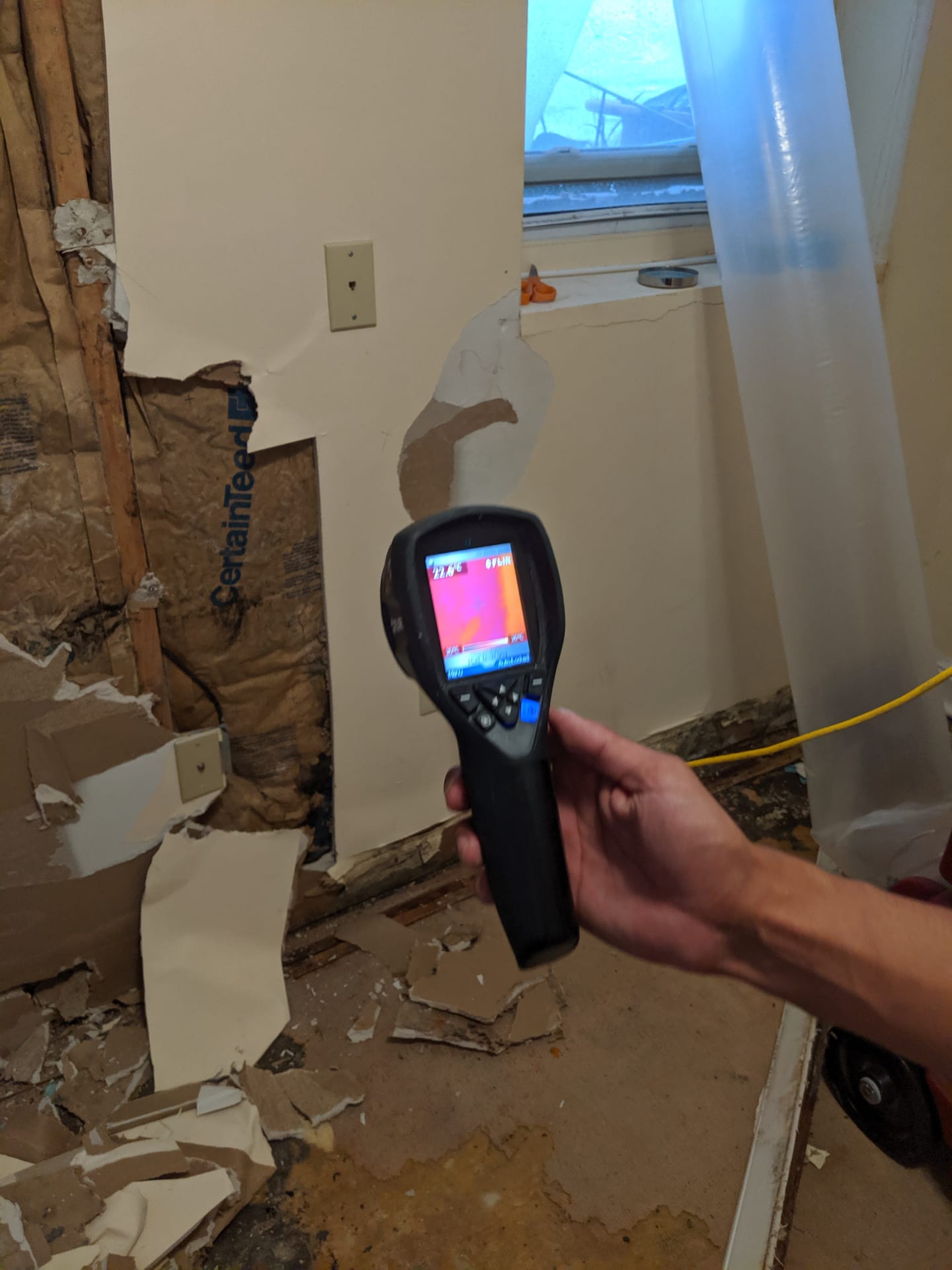 Environmental consultant using thermal imaging during a property inspection